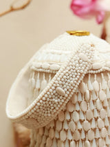 Bella White round embellished bag with handle, stylish accessory from The Tan Clan featuring intricate design details.