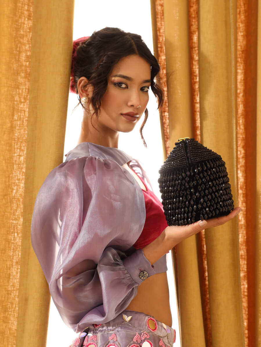 Black Emma round embellished bag with handle by The Tan Clan, featuring decorative details and a stylish, compact design.