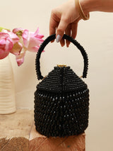 Black Emma Round Embellished Bag with Handle by The Tan Clan, featuring decorative accents and a sturdy handle.