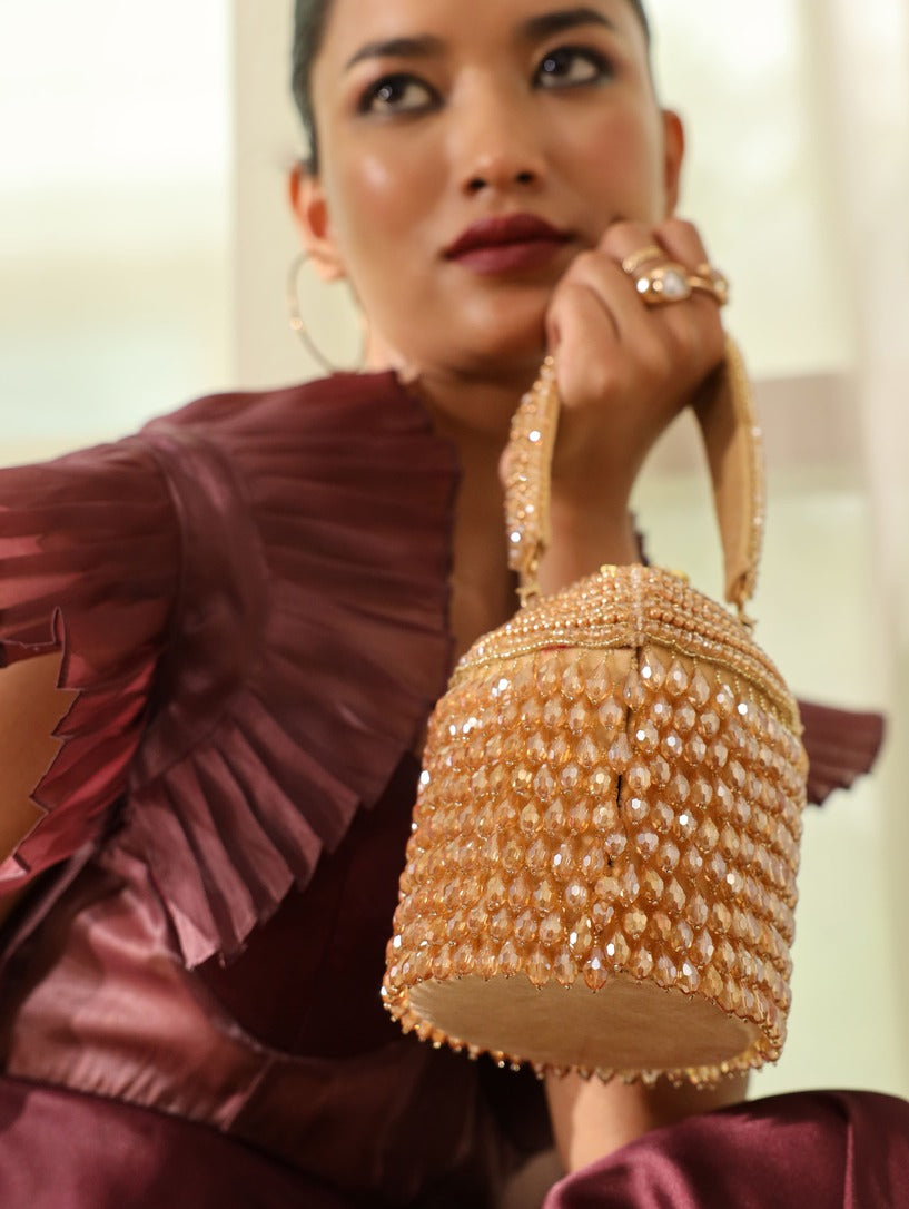 Black Emma round embellished bag with handle by The Tan Clan, featuring decorative accents and a stylish design.