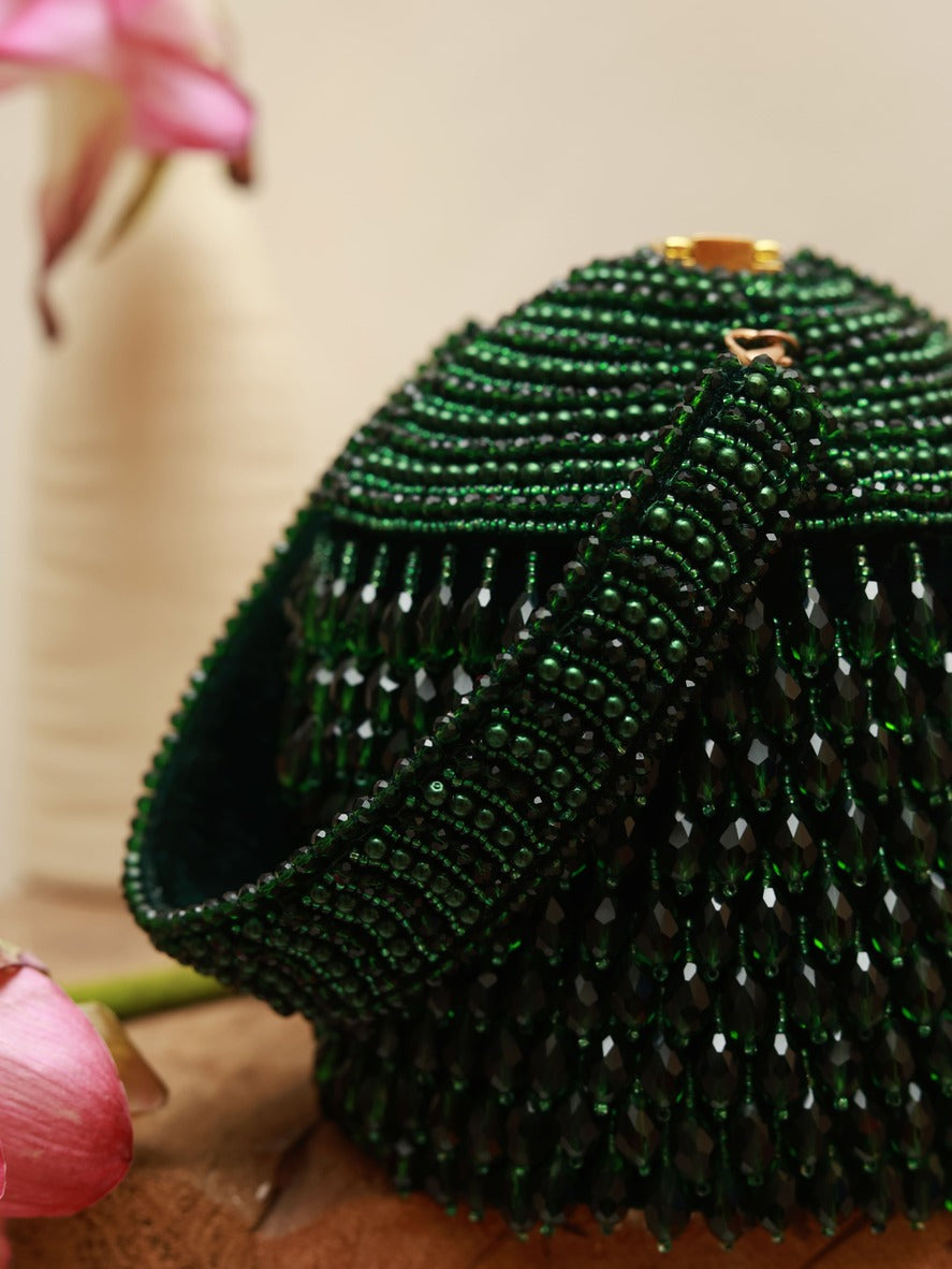 Black Emma round embellished bag with handle by The Tan Clan, featuring decorative accents and a sleek design.