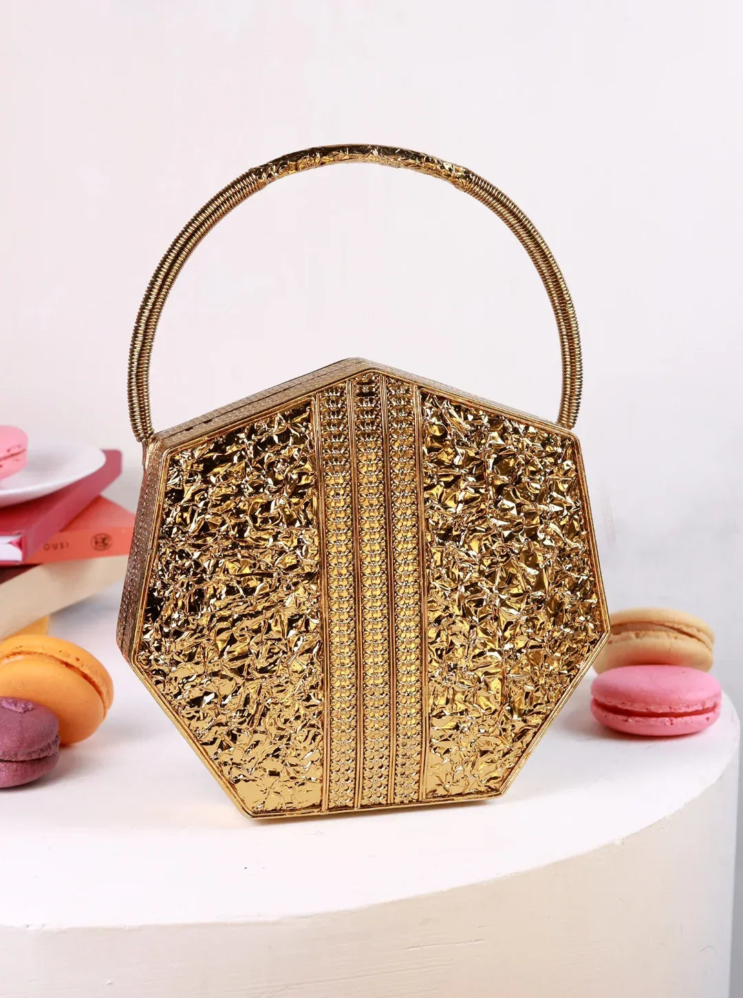 Alira brass clutch with handle by The Tan Clan, stylish small handbag featuring a sleek brass finish and convenient handle.