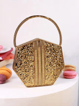 Alira brass clutch with handle by The Tan Clan, stylish small handbag featuring a sleek brass finish and convenient handle.