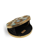 Beth Brass Clutch by The Tan Clan featuring a sleek brass exterior and minimalist design, perfect for elegant occasions.