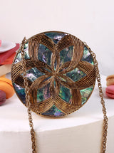 Beth Brass Clutch by The Tan Clan featuring a sleek, polished brass exterior and compact design for elegant evening use.
