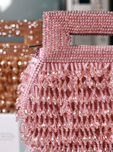 Pink pearl box clutch by The Tan Clan featuring a sleek rectangular shape and elegant pearl detailing.