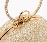 Gold sequined round clutch purse by The Tan Clan with shimmering, sparkly surface perfect for elegant occasions.
