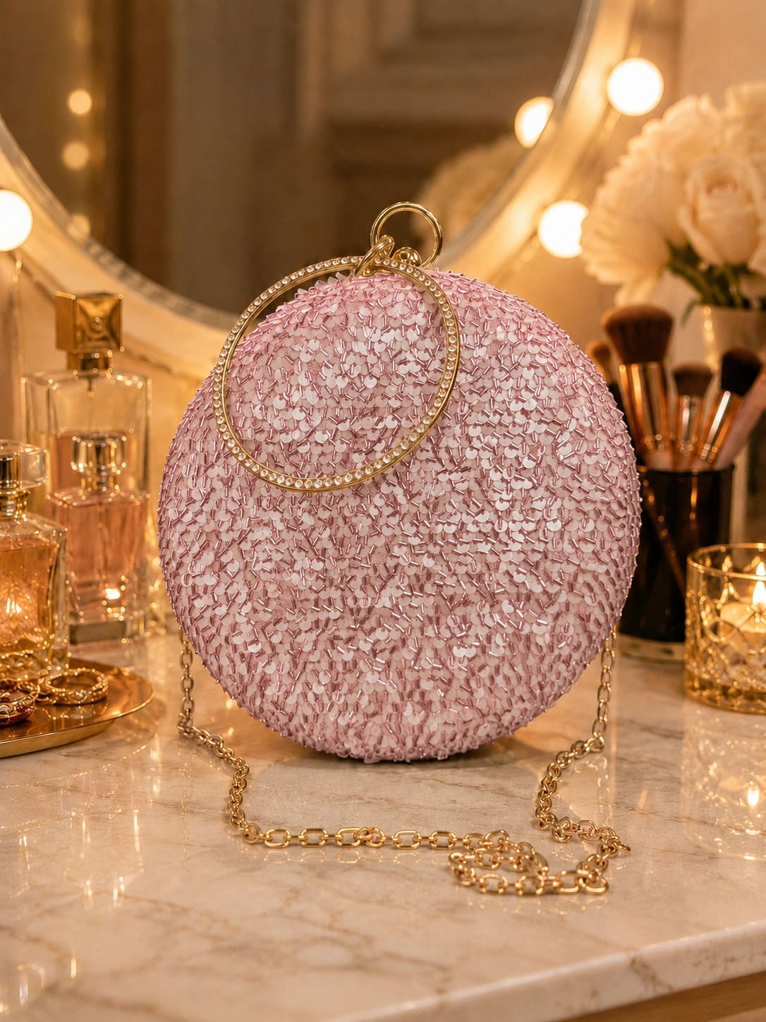 Pink sequined round clutch bag from The Tan Clan with shimmering, dazzling surface and elegant design.