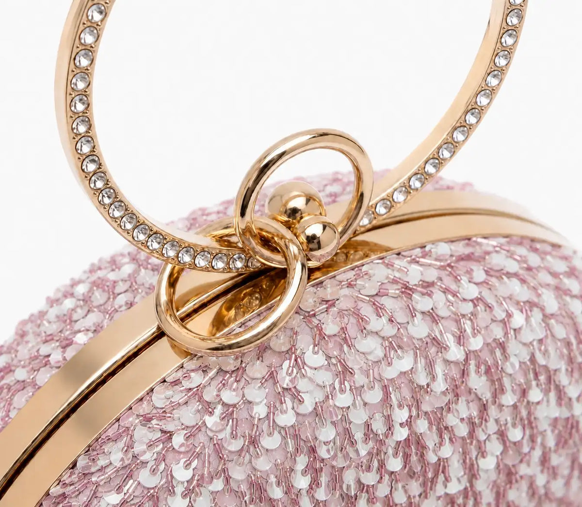 Dazzle Pink Sequined Round Clutch by The Tan Clan featuring shiny pink sequins and a compact, circular design.