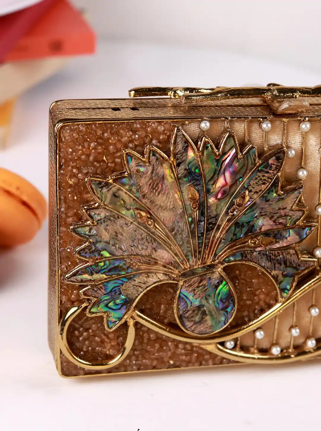 Elena Brass Clutch by The Tan Clan featuring a sleek metallic finish and compact design for elegant evening wear.