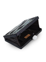 Eve Brass Clutch by The Tan Clan featuring a sleek gold-toned metallic surface and compact design.