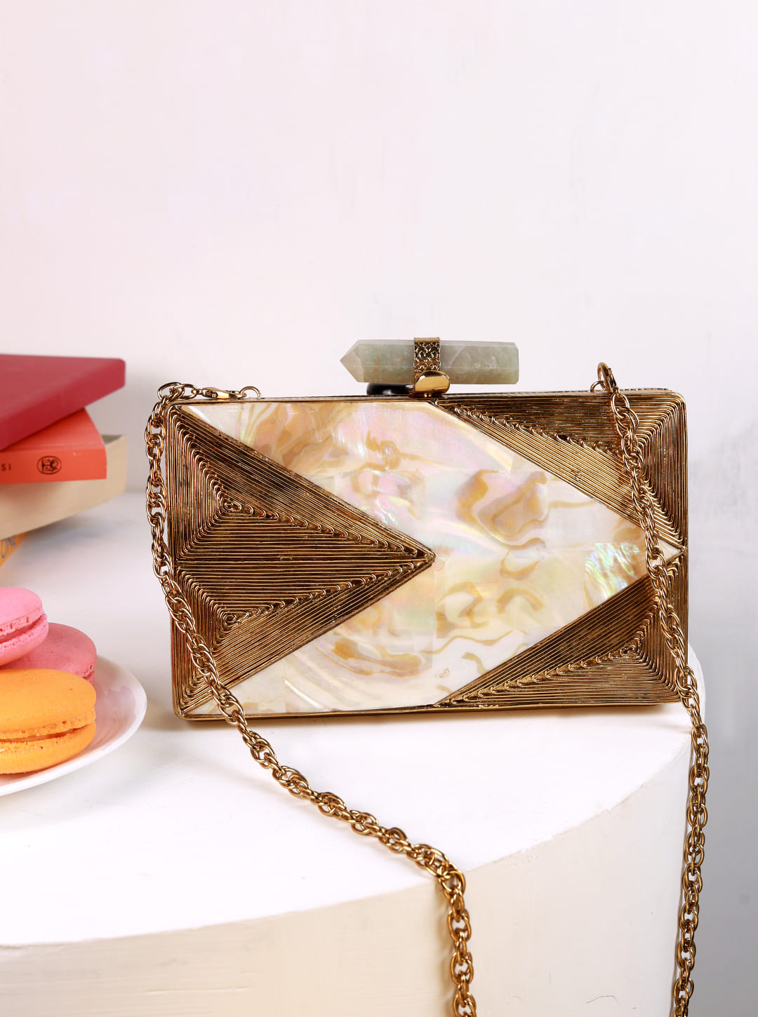 Krysty Mother of Pearl Brass Clutch by The Tan Clan featuring iridescent shell surface and elegant brass accents.