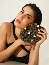 The Tan Clan Rhea Brass Clutch featuring a sleek, metallic finish and compact design for elegant evening wear.