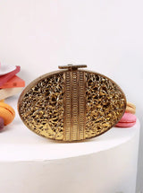The Tan Clan Rhea Brass Clutch with a sleek, metallic finish and compact design, ideal for elegant evening accessories.