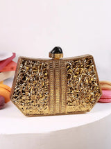 The Tan Clan Ruth wired brass clutch with a sleek design, featuring a textured brass finish and a compact shape.