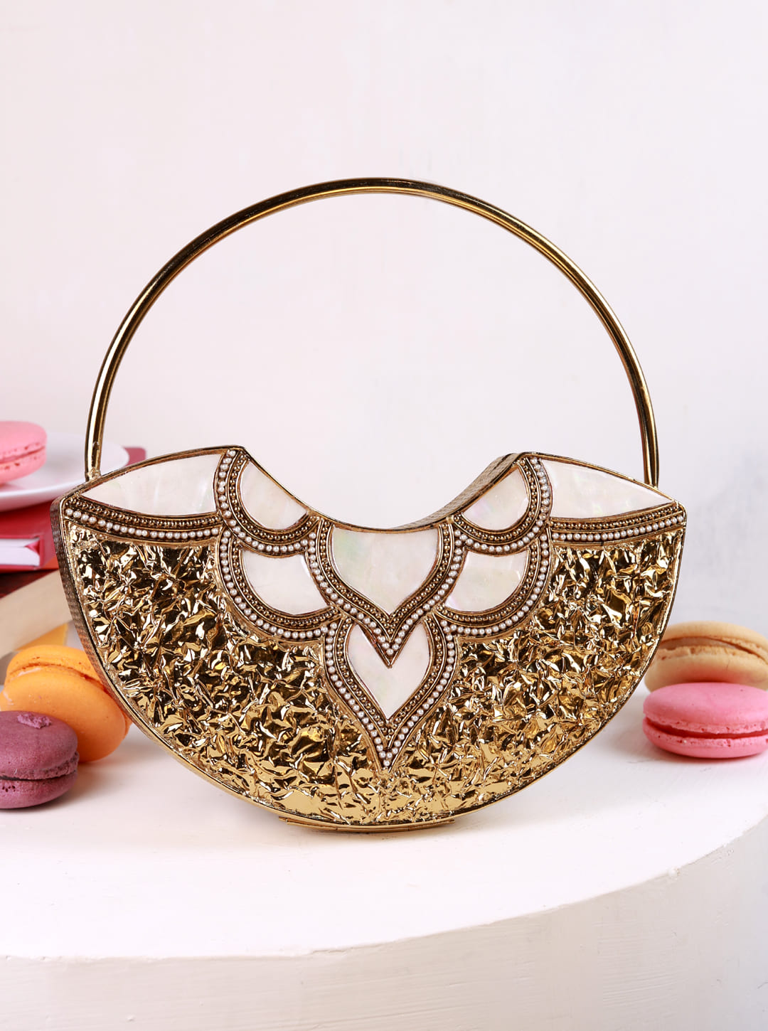Sasha brass clutch with handle from The Tan Clan featuring a sleek, shiny metallic finish and a stylish, functional design.