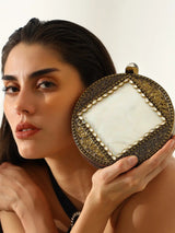 Seren Brass Clutch by The Tan Clan showing a sleek brass clutch with a smooth finish and elegant design.