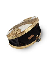 The Tan Clan Tracy Brass Clutch featuring a sleek, metallic finish and elegant design for evening or special occasions.