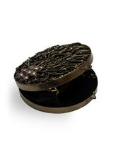 Vana Brass Clutch from The Tan Clan featuring a sleek metallic finish and compact design for elegant evening use.