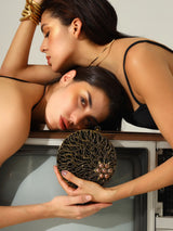 Vana Brass Clutch by The Tan Clan featuring a sleek brass finish and minimalist design, perfect for elegant occasions.