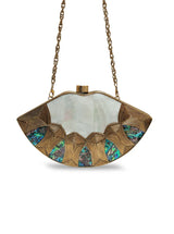 Zuri Mother of Pearl Brass Clutch by The Tan Clan featuring elegant pearl details and a sleek brass finish.
