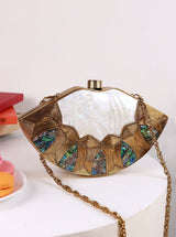 Zuri Mother of Pearl Brass Clutch by The Tan Clan featuring a sleek design with iridescent shell and brass accents.