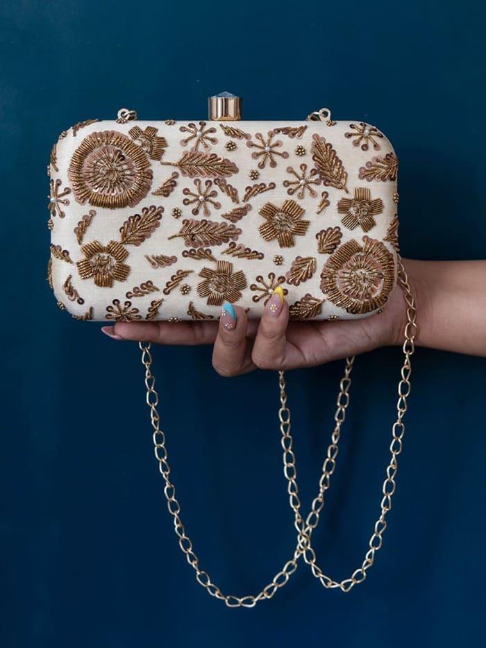 Beige hand-embroidered clutch bag by The Tan Clan with intricate embroidery, stylish accessory for special occasions.