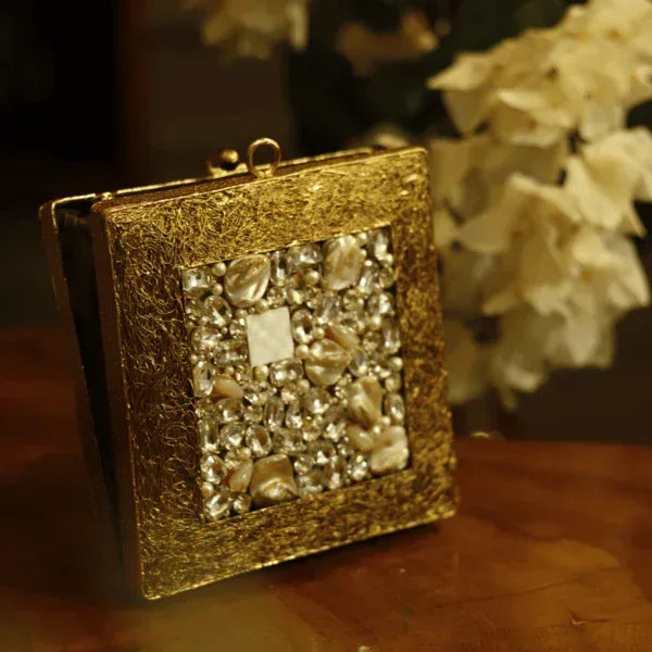 Aafreen embellished brass clutch with intricate details, featuring a decorative design and a compact, elegant shape.
