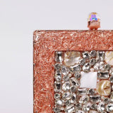 Elegant brass clutch bag with intricate embellishments from The Tan Clan, showcasing detailed craftsmanship and stylish design.
