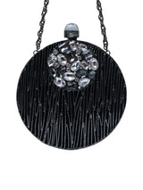 Aashna round brass clutch with embellishments, stylish accessory featuring intricate detailing and a polished finish.