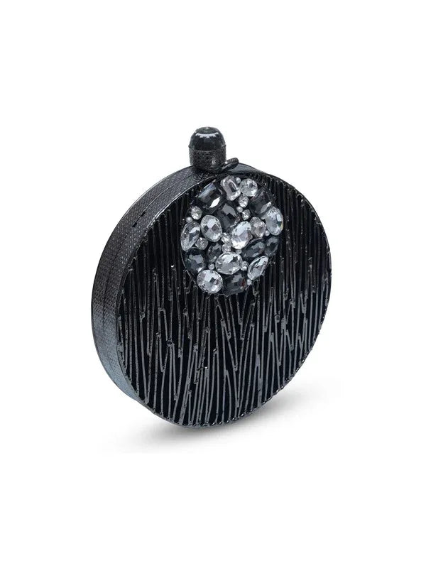 Aashna round brass clutch with intricate embellishments by The Tan Clan, featuring a polished brass finish and decorative details.
