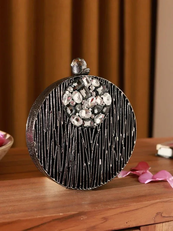 Aashna round brass clutch with embellishments from The Tan Clan, showcasing an elegant, decorative design perfect for special occasions.