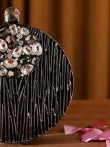 Aashna round embellished brass clutch by The Tan Clan featuring intricate design and elegant craftsmanship.