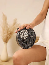Aashna round embellished brass clutch featuring intricate details and a polished finish, perfect for elegant occasions.