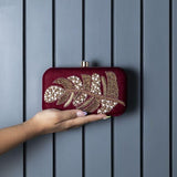 Afrah hand-embroidered leaf clutch by The Tan Clan featuring intricate embroidery and a vibrant leaf pattern.
