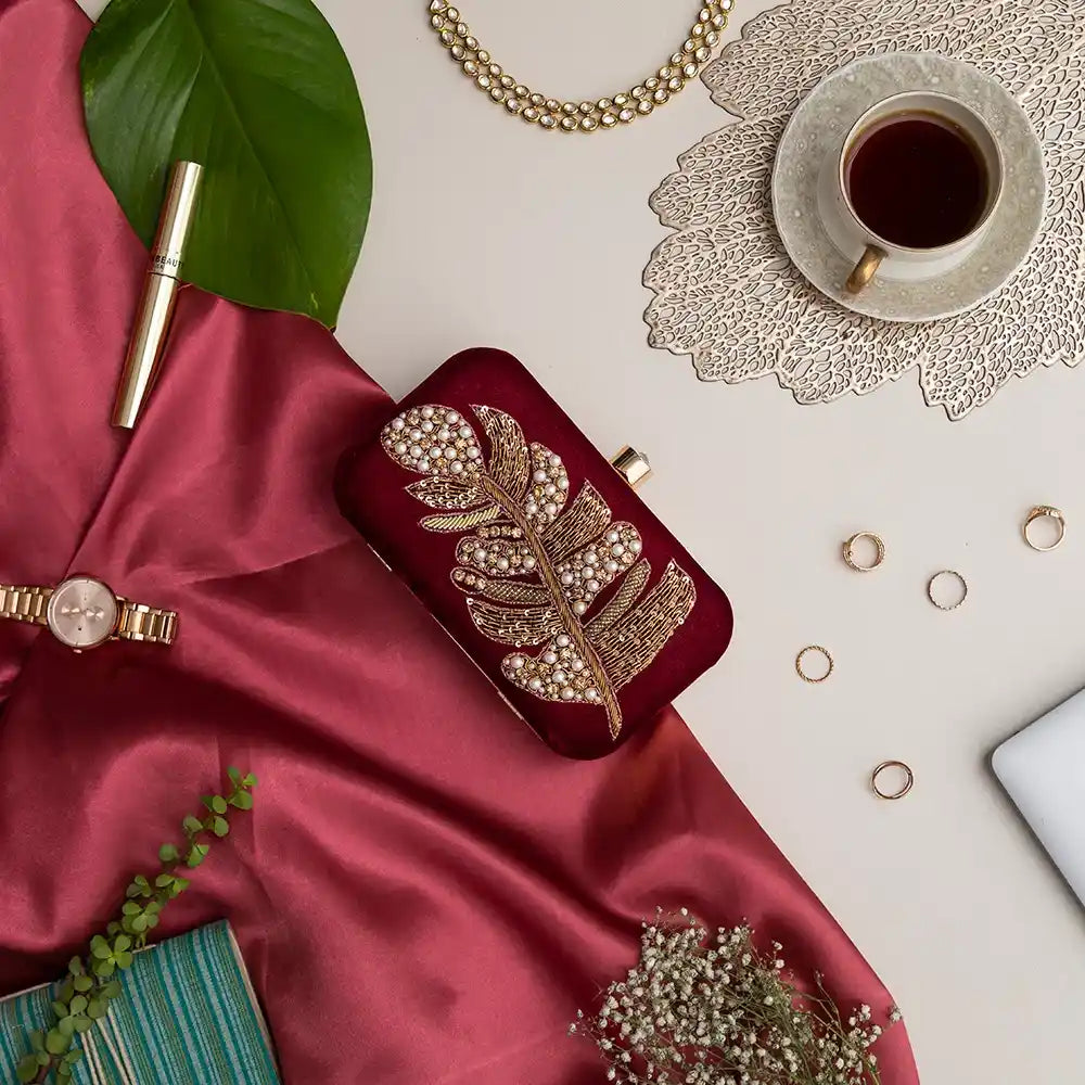 Afrah hand-embroidered leaf clutch by The Tan Clan featuring intricate leaf embroidery and a stylish, compact design.