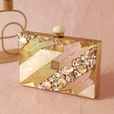 Aisha embellished mother of pearl clutch by The Tan Clan, featuring intricate beadwork and elegant design, on a neutral background.
