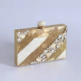 Aisha Embellished Mother of Pearl Clutch by The Tan Clan, featuring intricate embellishments and a sleek design.
