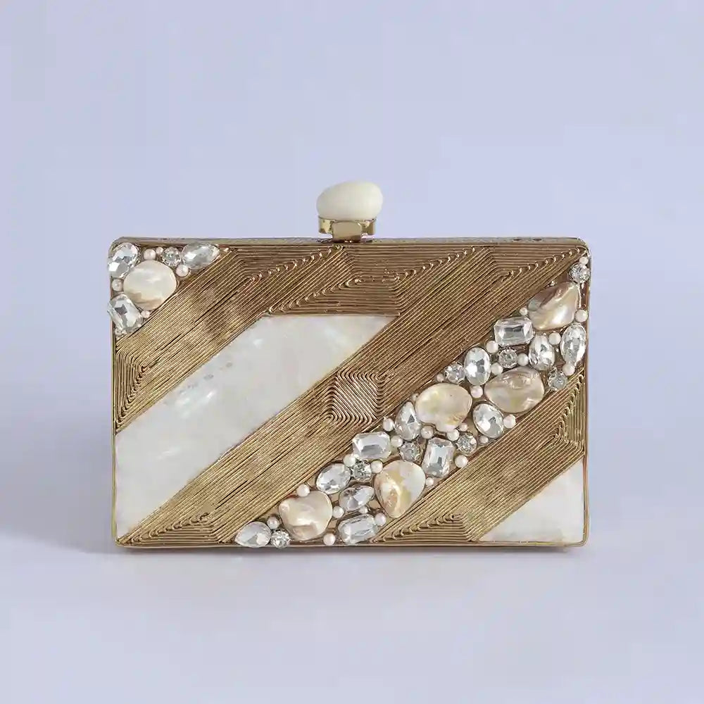 Aisha Embellished Mother of Pearl Clutch by The Tan Clan, featuring intricate embellishments and a sleek, elegant design.