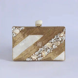 Aisha Embellished Mother of Pearl Clutch by The Tan Clan, featuring intricate embellishments and a sleek, elegant design.