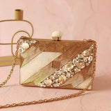Aisha embellished mother of pearl clutch by The Tan Clan, featuring intricate pearl accents and a sleek, elegant design.