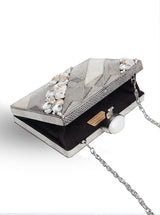 Aisha embellished Mother of Pearl clutch by The Tan Clan featuring intricate pearl detailing and a sleek elegant design.