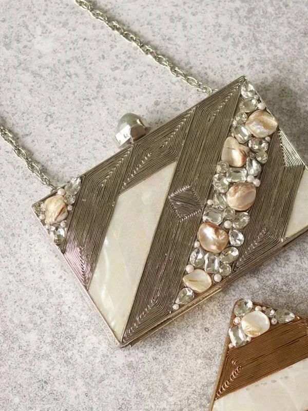 Aisha embellished mother of pearl clutch bag with intricate design and metallic accents, crafted by The Tan Clan.