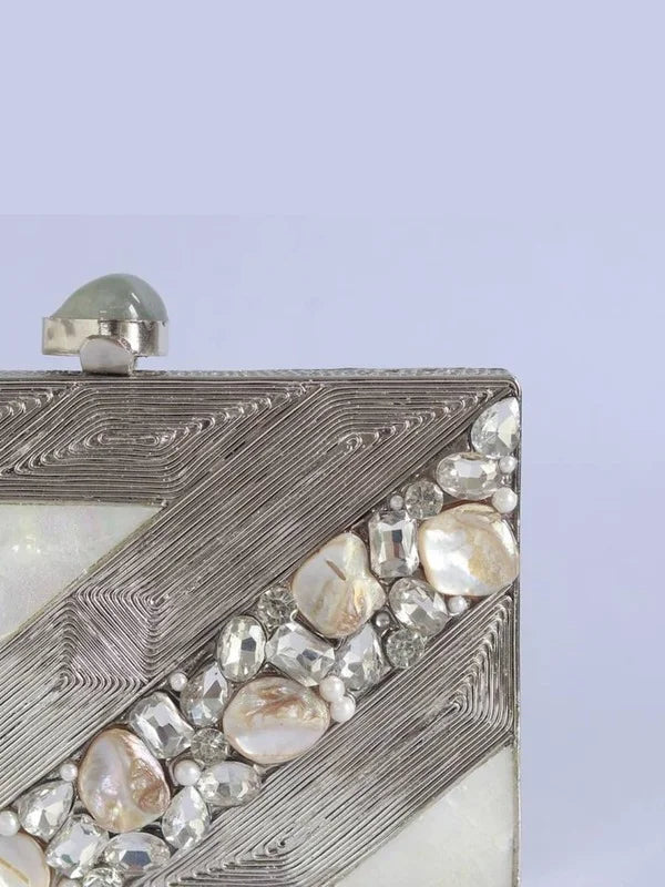 Aisha embellished mother of pearl clutch by The Tan Clan featuring intricate beadwork and a sleek, elegant design.