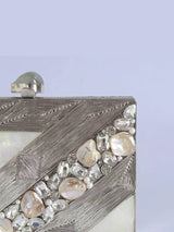 Aisha embellished mother of pearl clutch by The Tan Clan featuring intricate beadwork and a sleek, elegant design.