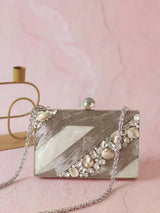Aisha Embellished Mother of Pearl Clutch by The Tan Clan, featuring intricate embellishments and a sleek, elegant design.
