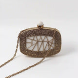Alia Mother of Pearl Clutch by The Tan Clan featuring a shimmering pearl exterior and elegant design.