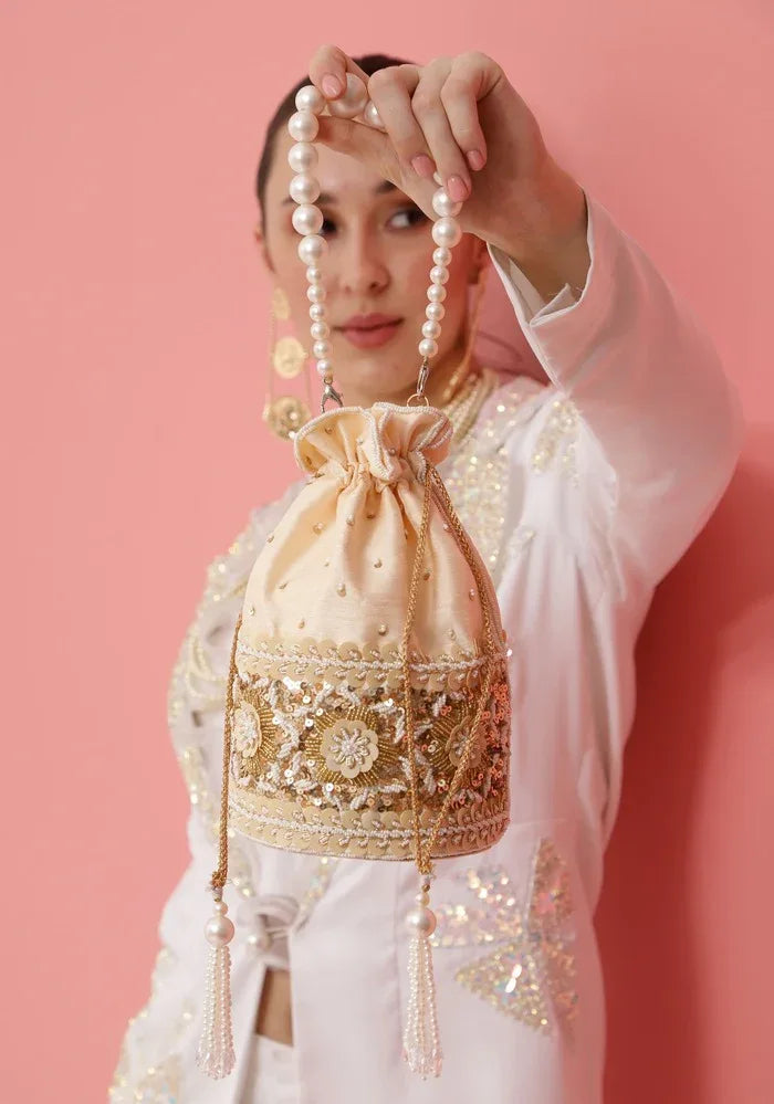 Ama Potli bag with pearl handle from The Tan Clan, featuring intricate embroidery and elegant design for special occasions.