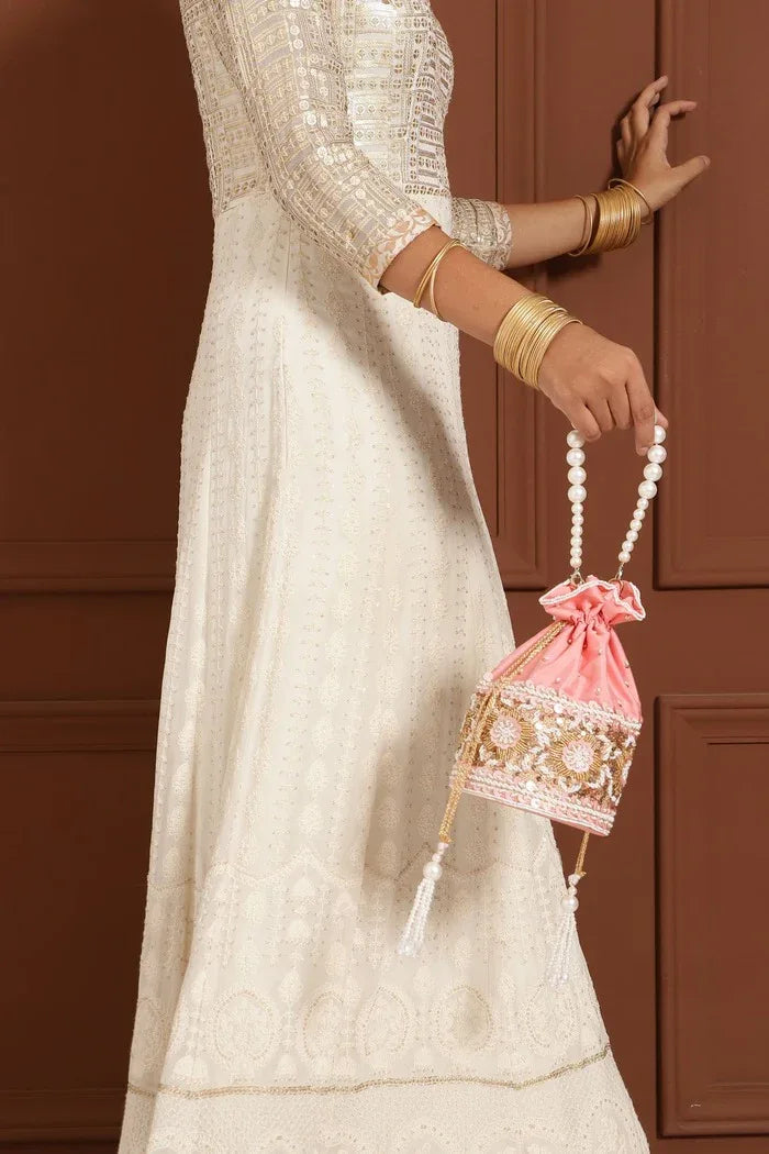 Elegant Ama Potli Bag from The Tan Clan with a pearl handle, featuring intricate design and traditional craftsmanship.