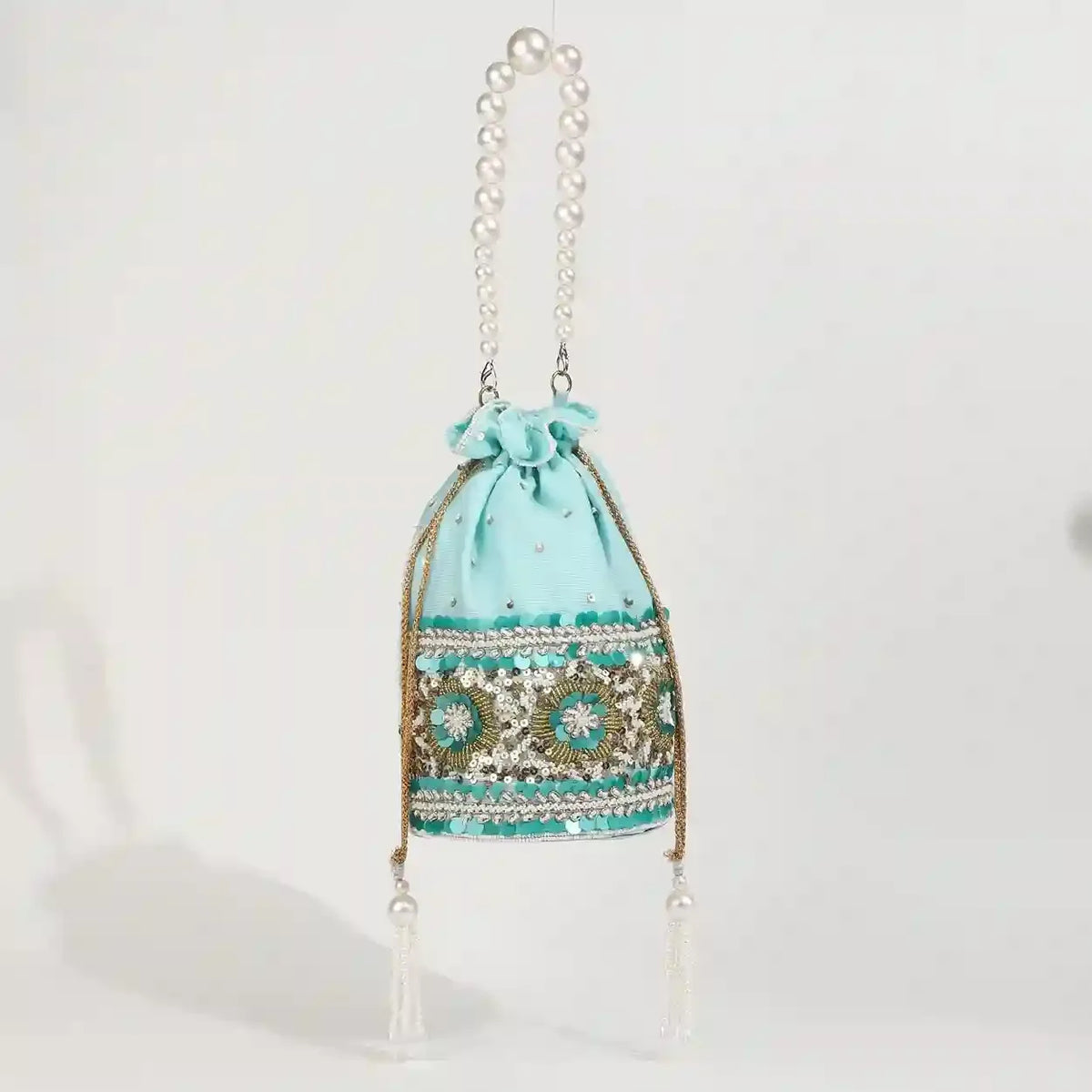 Ama Potli bag with pearl handle from The Tan Clan, featuring traditional design and elegant pearl accents.